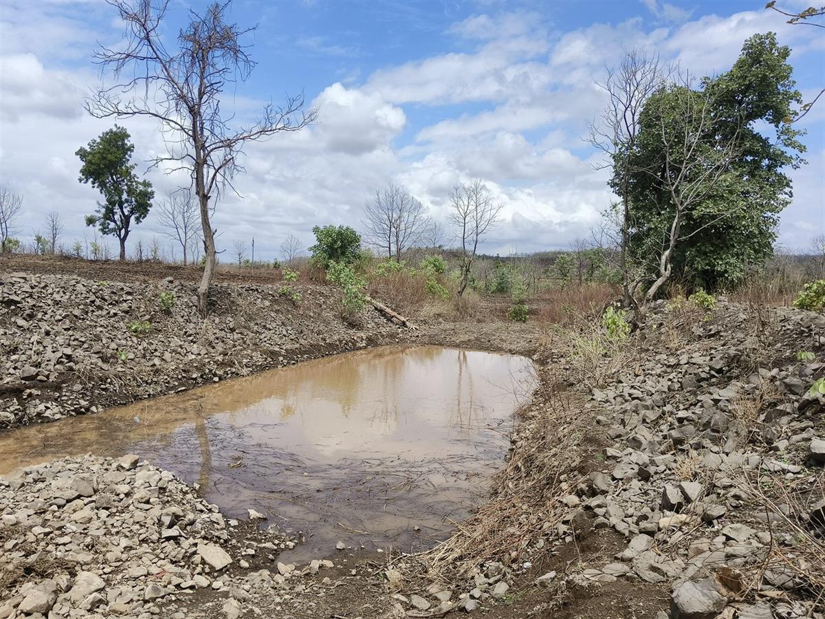 A completed recharge structure holding water after the monsoon